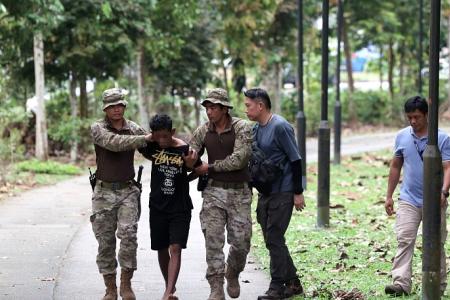 Man banned from entering Singapore among 5 arrested in forested area