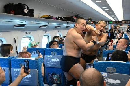 Japanese wrestlers in all-out high-speed brawl entertain passengers on bullet train 