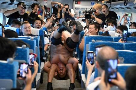 Japanese wrestlers in all-out high-speed brawl entertain passengers on bullet train 