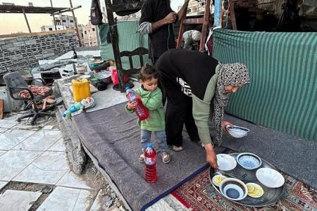 Gaza's displaced break fast with canned food in the rubble