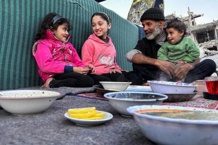 Gaza's displaced break fast with canned food in the rubble