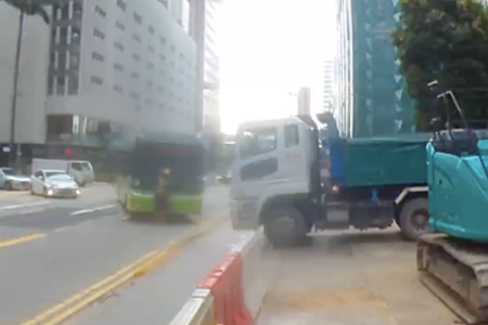 Bus at Anson Road drives over construction worker