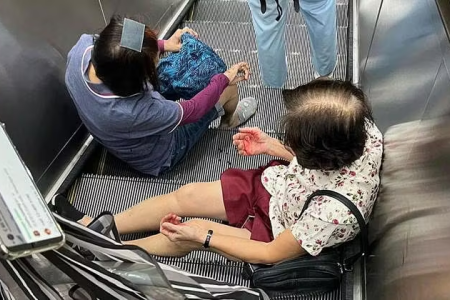 Man falls down MRT station escalator, lands on 2 commuters 