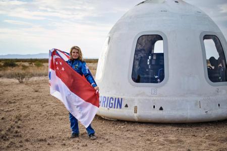 She may not be a citizen yet but she proudly took S'pore flag to outer space