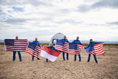 She may not be a citizen yet but she proudly took S'pore flag to outer space