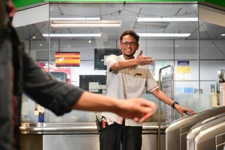 Young man with special needs gets help from SMRT staff on train