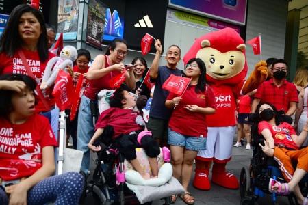 Thousands cheer on Paralympians in celebratory bus parade