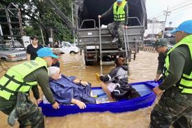 Thai soldiers evacuating residents from their flooded houses in the tourist city of Chiang Mai, northern Thailand, on Sept 26.