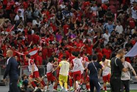 The Singapore football squad celebrating in front of the home fans after scoring the equalising goal against China during the World Cup 2026 and Asian Cup 2027 R2 qualifiers held at the National Stadium on March 21, 2024.