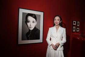 Singapore actress Fann Wong, next to a 2005 photo of her taken by Singaporean fashion and celebrity photographer Wee Khim, on April 4. She is featured in the exhibition Goddess: Brave. Bold. Beautiful. at Marina Bay Sands' ArtScience Museum.