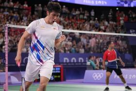 Singaporean shuttler Loh Kean Yew in action against Uriel Canjura of El Salvador.