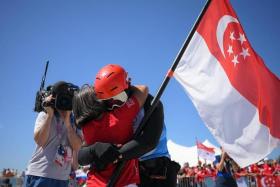 Singaporean Kitefoiler Maximilian Maeder hugs his mother after race 3of the Paris 2024 Olympics Men’s Kite final at the Marseille Marina on August 9, 2024.