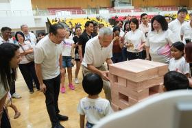 Senior Minister Lee Hsien Loong (centre) interacting with young children at the launch of the Teck Ghee Preschool Network on Sept 29.