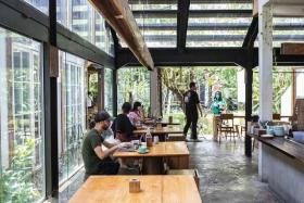 Customers work on laptops at a cafe in the Seminyak area of Bali, Indonesia, on Oct 29, 2021. 