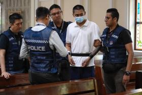 The suspect, Basnayake Keith Spencer, back at the scene at St Joseph&#039;s Church in Bukit Timah on Dec 6.