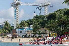 Various paddler and canoe groups participating in the re-opening of Siloso Beach on Aug 3.