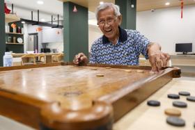 Mr Lam Shaw Ying, 88, a retired school supplier, playing carrom at the Good Old Place in Harmony Village @ Bukit Batok on Jan 7. 