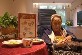 Madam Elizabeth Low with softmeal siu mai, chwee kueh and pandan cake at The Salvation Army Peacehaven Nursing Home.