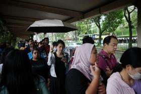 Commuters queueing for the bridging bus service towards Buona Vista from Jurong East on Sept 26.