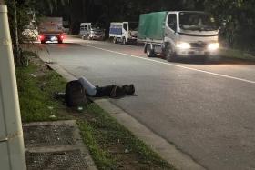 A migrant worker sleeping off the effects of alcohol on the road, as vehicles gave him a wide berth.