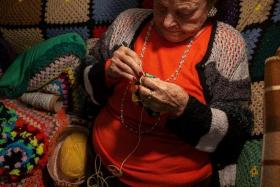 Ioanna Matsouka, 93, knits scarves in her house in Athens, Greece, March 6, 2024. Matsouka has knit thousands of brightly coloured scarves for children in need, from Greece to Ukraine. REUTERS/Karolina Tagaris