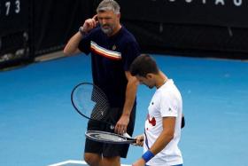 FILE PHOTO: Tennis - Australian Open - Melbourne Park, Melbourne, Australia - January 20, 2024 Serbia's Novak Djokovic and his coach Goran Ivanisevic react during a practice session REUTERS/Issei Kato/File Photo