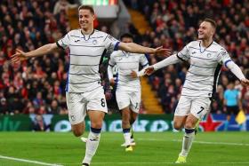 Atalanta&#039;s Mario Pasalic celebrates scoring their third goal in the 3-0 Europa League win over Liverpool with Teun Koopmeiners.