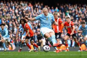 Soccer Football - Premier League - Manchester City v Luton Town - Etihad Stadium, Manchester, Britain - April 13, 2024 Manchester City&#039;s Erling Braut Haaland scores their third goal from the penalty spot REUTERS/Molly Darlington