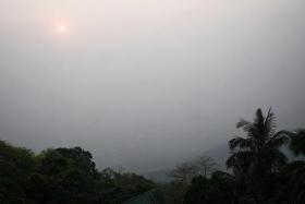 High levels of air pollution obscure the view of Chiang Mai from atop Wat Phra That Doi Suthep temple on March 15.