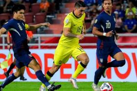 Malaysia&#039;s Sergio Aguero driving forward despite the attentions of Peeradon Chamratsamee (left) and Suphanat Mueanta at the Asean Championship match on Dec 14.