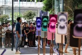 Shoppers queueing outside the Orchard Road Apple Store to buy the new iPhone 16 on Sept 20.