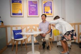 Minister for Health Ong Ye Kung receiving his vaccination at the Unity Pharmacy within FairPrice Xtra supermarket at Parkway Parade on Oct 28.