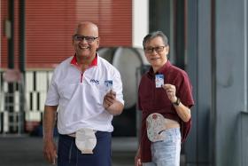 President of Ostomy Association of Singapore (OAS) Ellil Mathiyan Lakshmanan (left) and retiree William Chong live with ostomy bags and will benefit from owning the OAS medical identification card.