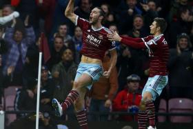 Andy Carroll celebrates after scoring for West Ham United.