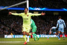 Luis Suarez celebrates after scoring for Barcelona against Manchester City in the Champions League.