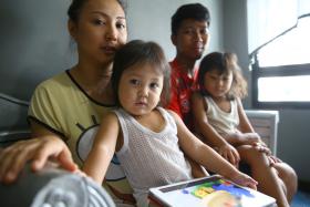 Madam Noreen and Mr Muhammad Fazlee&#039;s daughter (left) had her head trapped in the railings outside their flat. She had to be rescued by a foreign worker. 