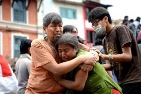 A Nepalese man and woman devastated and traumatised in the aftermath of the earthquake.