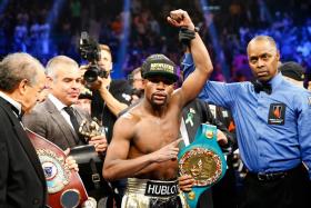 Floyd Mayweather Jr. celebrates the unanimous decision victory during the welterweight unification championship bout. They were celebrities galore at the match touted as the biggest this century. 