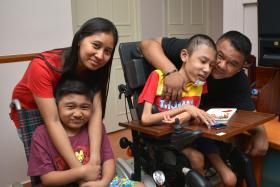 STAYING STRONG: (Above, from far left) Madam Rosidah Omar, with her sons Muhd Danial, 10 and Mohd Sufyan, 15, and her husband Sohaimi Wari. An old photograph of the boys when they could still walk.