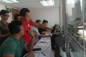 CONTROL ROOM: LTC Koh Ting You (in red) working with the committee at the sixth storey of the National Gallery Singapore.