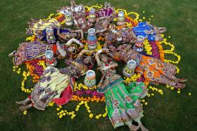 Women dressed in traditional attire posing after taking part in rehearsals for the Navratri festival in Ahmedabad, India.