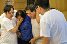 Mr Tan Boon Sin&#039;s widow returned home and saw blood on the road outside the family home but did not realise her husband and son had both been murdered.