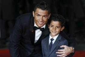 Ronaldo and his son Ronaldo Jr, 5,  pose on the red carpet at the world premiere of Ronaldo at Leicester Square in London