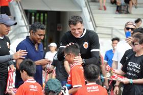 WELL DONE: (From far left) ActiveSG coach Robin Chitrakar, national coach V Sundramoorthy and ActiveSG academy principal Aleksandar Duric giving out medals to participants yesterday. 