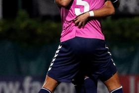 JOY: Albirex&#039;s Naofumi Tanaka (No. 5) celebrating with a teammate after making it 2-0.