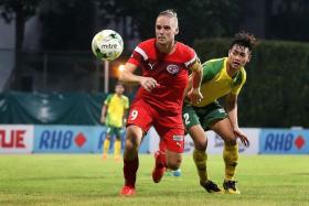 IN VAIN: A scoring performance from Home striker Ken Ilso (in red) is not enough, as the Protectors bow out of the RHB Singapore Cup.