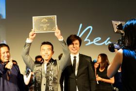 Manhunt Senior winner Mr Stanley Nam (centre) made a beeline for his mother when he was announced as the winner. 