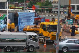 Police on the scene at Outram Road where a crane collapsed at the construction site for the Outram Park Station on the Thompson-East Coast line.