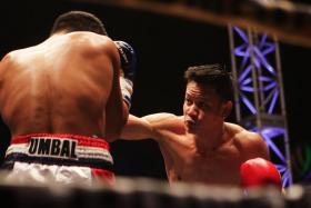 Muhamad Ridhwan (right) defeating Jebson Umbal of the Philippines in the IBO intercontinental featherweight title fight at the Singapore Indoor Stadium.