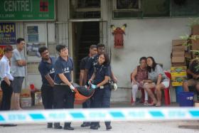 Body of a man being moved. He was killed after falling into a dough making machine at Ng Kian Seng Confectionery at 17 Bedok South Road.